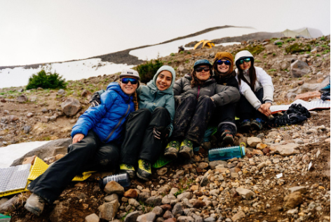 Part of the AWE Expedition team resting together on Mount Baker